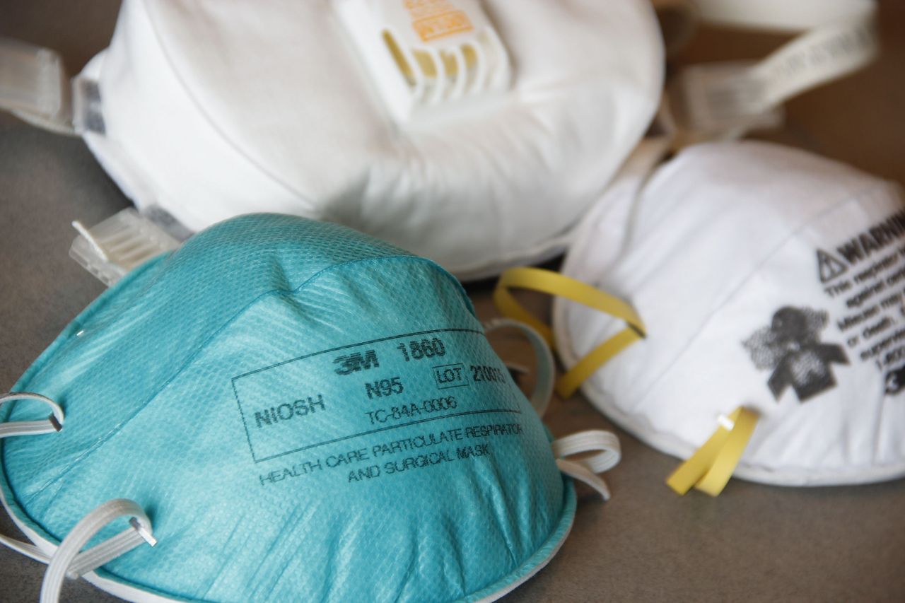 Close-up of N95 and KN95 respirator masks side by side showing strap and seal design